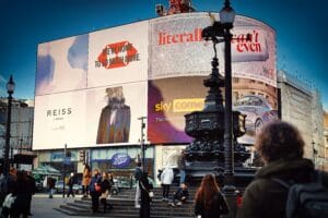 Large digital LED Video Wall billboards in a busy city center displaying advertisements